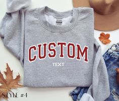 Custom Sweatshirt, Custom Varsity Crewneck, Custom Shirt, Personalized Sweatshirt, University Sweaters, Custom Quote, Vintage Sweatshirt. Our sweatshirts are made with 50% cotton and 50% polyester. Custom designs are available in other shirt styles. Go to our shop homepage for more options! **Our custom shirts are also available with embroidered text** https://www.etsy.com/listing/1672145815/custom-embroidered-varsity-crewneck Place Your Order With These Simple Steps: 1. Choose your size and shi Customizable Varsity Tops For Streetwear, Casual Customizable Sweatshirt For Fall, Customizable Casual Fall Top, Customizable Casual Tops For Fall, Casual Long Sleeve Tops With Custom Text, Casual Fall Sweatshirt For Customization, Custom Text Crew Neck T-shirt For Fall, Casual Custom Text T-shirt For Fall, Customizable Cotton Varsity Tops