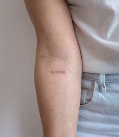 a woman with a small tattoo on her arm