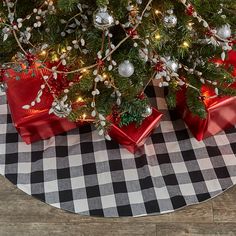 two presents under the christmas tree on a checkered tablecloth