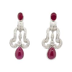 Cabochon Ruby 4.84 carats, Ruby 1.10 carats with Diamond 0.75 carat Earrings set in 18 Karat White Gold Settings Width: 1.5 cm Length: 3.5 cm Total Weight: 11.87 grams "We first opened doors in 1980 when it was then situated in the vicinity of the Victory Monument; a small and modest storefront with a couple of counters. From its humble beginnings to where it stands today, our company has proven its abilities as a jeweler. Since the beginning, we have been supplying fine quality pieces to dealers, wholesalers and customers worldwide. From then till now, our business still interrelates its name with quality products and excellent service, where commitment and sincerity toward customers will always be its motto." Stunning Aesthetic, Cabochon Ruby, Noble Lady, Chanel Jewelry, Jewelry Brand, Ruby Diamond, Earring Jewelry, Belle Epoque, Earrings Set