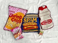 three hand towels and two snacks on a bed