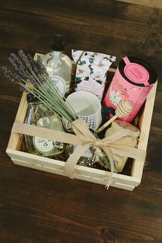 a wooden box filled with lots of different items on top of a table next to a cup