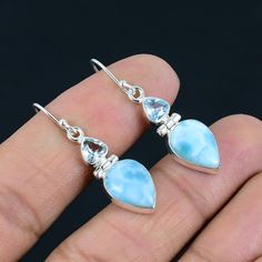 Natural Blue Larimar with Blue Topaz Gemstone Earrings | Solid 925 Sterling Silver | Handmade Dangle Drop Silver Earrings for Women & Girls   Gemstone - Larimar & Blue Topaz Gemstone Creation - Natural Metal - Silver Earrings Gross Weight:- 6.00 Grams, Earrings Length With Hook:- 1.50" Inch,  Gemstone Shape:- Pear & Triangle,  Larimar Size:- 10 * 14 mm, Blue Topaz Size:- 5 * 5 mm. Metal Purity - 925 Sterling Silver Handmade Earrings Note - Due to the Natural Formation of this Gemstone. Slight variation in texture and color but stone shape is same. Listing photo showing the design. Each Stone Color Little Bit Differ then the photo of the listing.  Benefits of Wearing Larimar Gemstone:- Larimar is an earth-healing stone. It connects with nature and will counteract imbalances in the earth's e Silver Larimar Dangle Jewelry, Light Blue Drop Jewelry For Gift, Blue Larimar Dangle Earrings, Silver Larimar Dangle Earrings, Light Blue Sterling Silver Drop Earrings, Blue Larimar Earrings For Gift, Nickel-free Light Blue Sterling Silver Jewelry, Blue Larimar Dangle Jewelry, Elegant Larimar Dangle Earrings