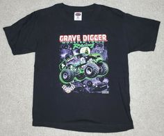 Vintage Grave Digger Tshirt Youth Medium 1999 Monster Trucks. Condition is Pre-owned very goid condition no holes or stains no cracks in graphics and still dark black not faded.  Shirt measures 18" armpit to armpit laying flat and 23" top of shoulder to bottom hem. Shipped fast & free with USPS First Class. Grave Digger, Junk Drawer, Dark Black, Tshirt Print, Monster Trucks, Trucks, Mens Graphic Tshirt, Mens Tshirts, Quick Saves