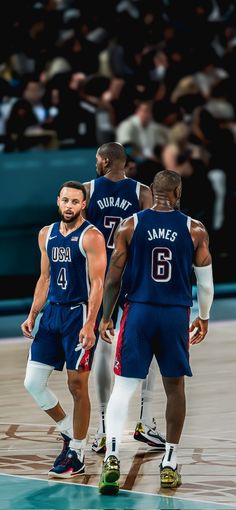 three basketball players standing on the court during a game