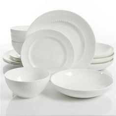 white dishes are stacked on top of each other in the same bowl and plate set