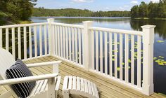 a white chair sitting on top of a wooden deck next to a body of water