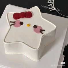 a hello kitty cake on a white plate