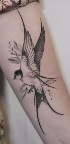 a small bird tattoo on the arm