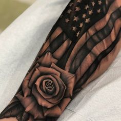 an american flag with a rose tattoo on the arm