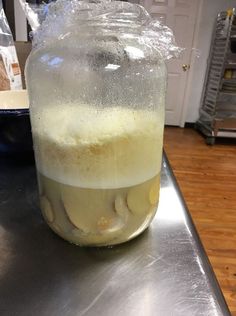 a jar filled with liquid sitting on top of a counter