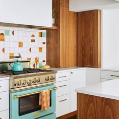 a kitchen with an oven, stove and cabinets