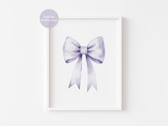 a white frame with a purple bow on it