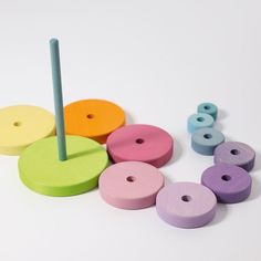 colorful wooden toys are arranged on a white surface