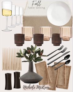 a table setting with wine glasses, napkins and utensils