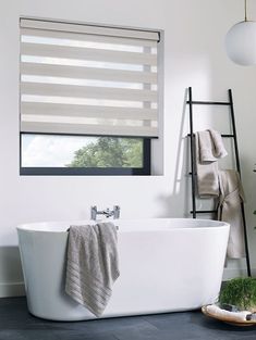 a white bath tub sitting next to a window