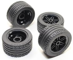 four black plastic wheels with spokes on them