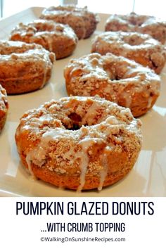 pumpkin glazed donuts with crumb toppings on a white platter and text overlay