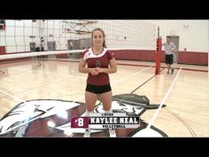 a female volleyball player standing on the court