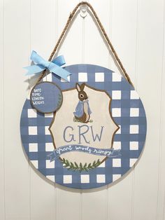 a blue and white sign hanging on the side of a door that says grw