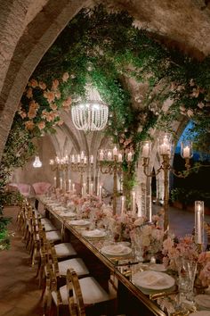 a long table is set with flowers and candles for an elegant wedding reception at the castle