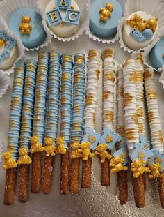 a table topped with lots of blue and gold desserts