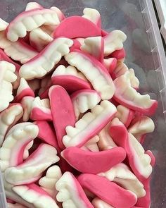 a plastic container filled with pink and white candy