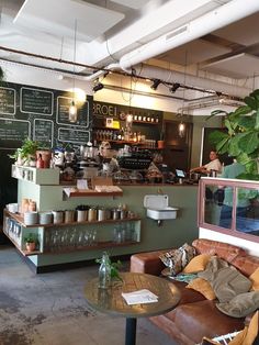 the inside of a coffee shop with tables and chairs