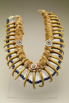 an elaborate necklace made out of animal tusks