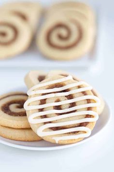 some cookies with icing on a white plate