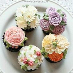 cupcakes decorated with flowers on a plate