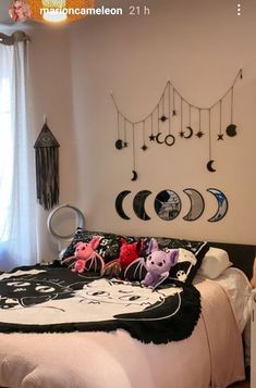 a bed room with a neatly made bed and lots of decorations on the wall above it