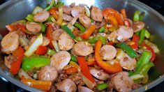 a pan filled with meat and vegetables on top of a stove next to a frying pan