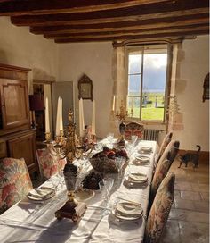 the dining room table is set with place settings