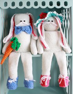 two crocheted stuffed animals sitting on top of a shelf