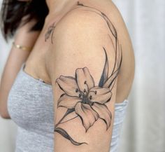 a woman with a flower tattoo on her arm