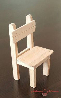 a small wooden chair sitting on top of a table