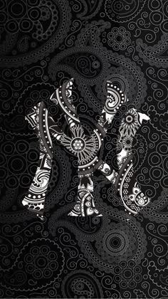 an ornate black and white pattern with two birds in the center, on a dark background