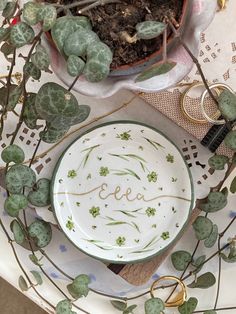 a plate with the word eeee written on it next to plants and other items