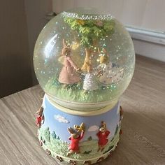 a snow globe sitting on top of a wooden table