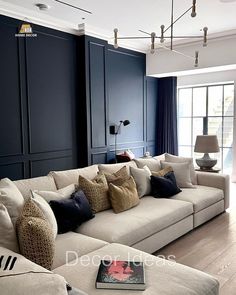 a living room filled with furniture and a large white couch in front of a window