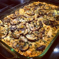 a casserole dish filled with mushrooms and cheese