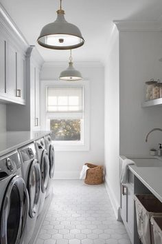 a washer and dryer in a white laundry room