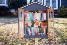 a little library in the shape of a house