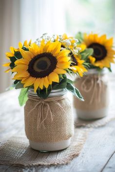 two mason jars with sunflowers in them