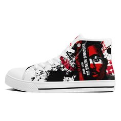 a pair of white sneakers with red and black paint splattered on them