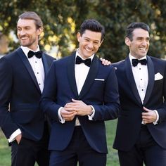 three men in tuxedos are smiling for the camera