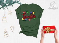 "Christmas Teacher Shirt, Christmas Lights Shirt, Christmas Shirt, Teacher Shirt, Teacher Shirts, Teacher Gifts, Christmas Gifts Link for Backside Printing https://www.etsy.com/listing/1091793828/backside-upgrade?ref=shop_home_active_1&frs=1 - How To Order - Please, check and review all photos Choose your t-shirt color and size Click add to cart. You can go back to add more product Click \"Proceed to check out\" -PRODUCT- We use high quality soft style shirt brands. Solid colors: 100% Preshrunk Cotton, Heather Colors: 52% Cotton - 48% Poly We make black design for White, Pink, Athletic Heather, Orange and Heather Peach White design is used by other colored shirts. -CARE INSTRUCTIONS- Wash item inside out in cold water Do not bleach Do not dry clean Do not iron directly on the design. Tumbl Teacher Christmas, White Design, Teacher Favorite Things, Black Design, Teacher Shirts, Christmas Shirts, Christmas Lights, Handmade Christmas, Teacher Gifts