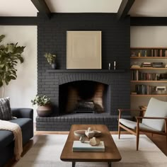 a living room filled with furniture and a fire place in front of a brick fireplace