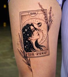 a woman's thigh with an image of the moon and stars on it, in black ink